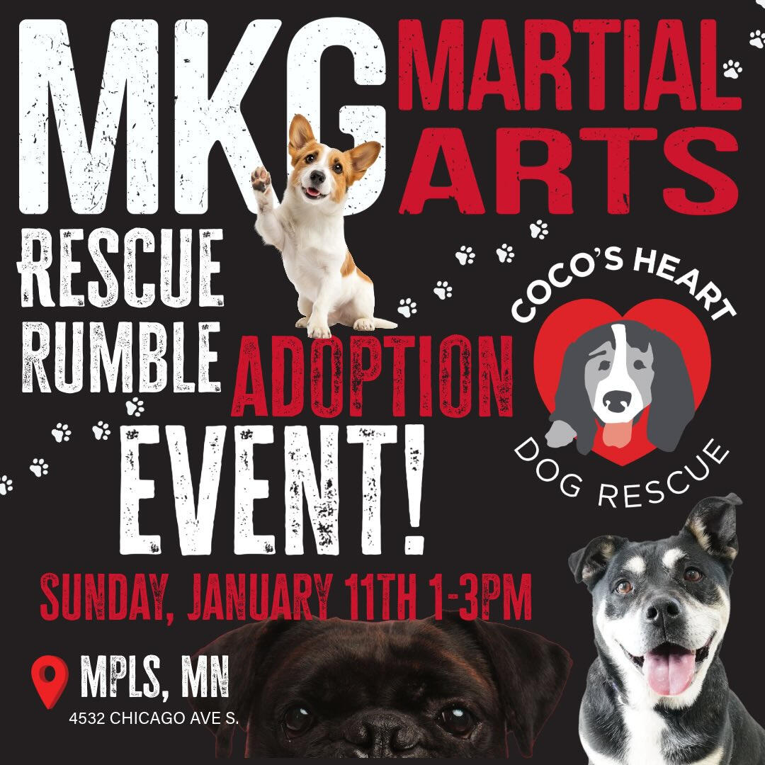 Photo of J. standing behind a farmers' market table of bagels, rye bread, focaccia, and cornbread. J. holds three tupperwares of additional baked goods.